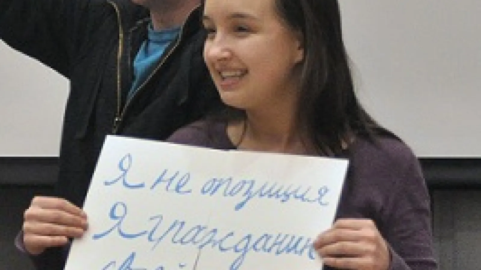 photo of a russian student holding a sign